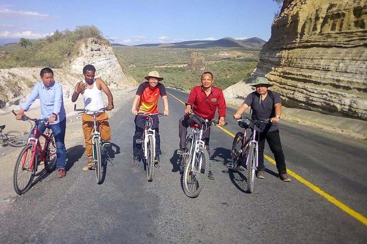 a group of people riding bikes on a road