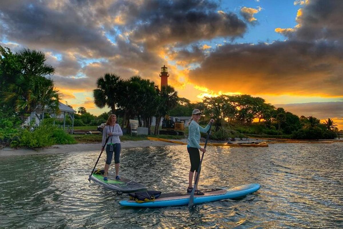 two people are standing on paddle boards in the water