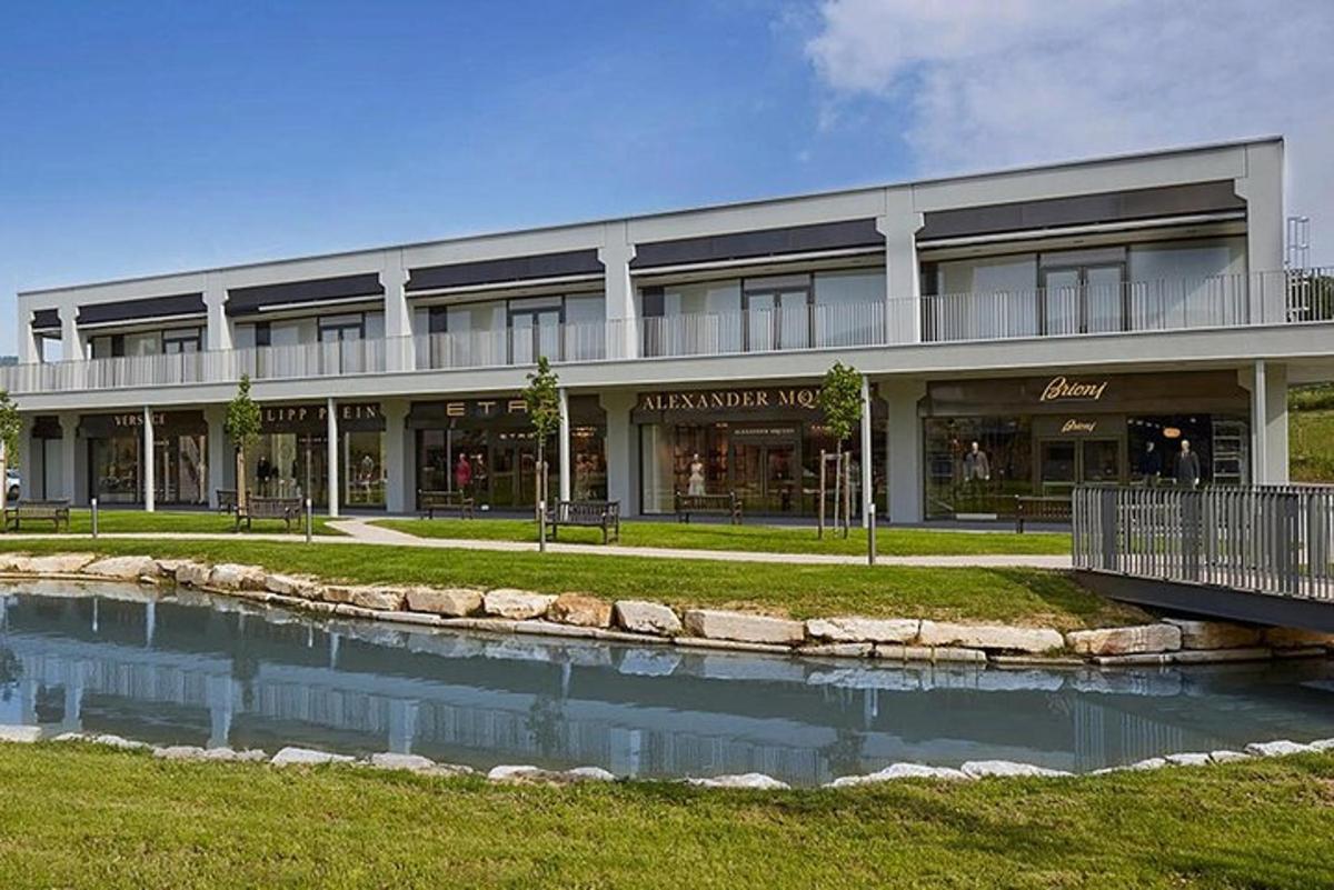 a large building with a pond in front of it