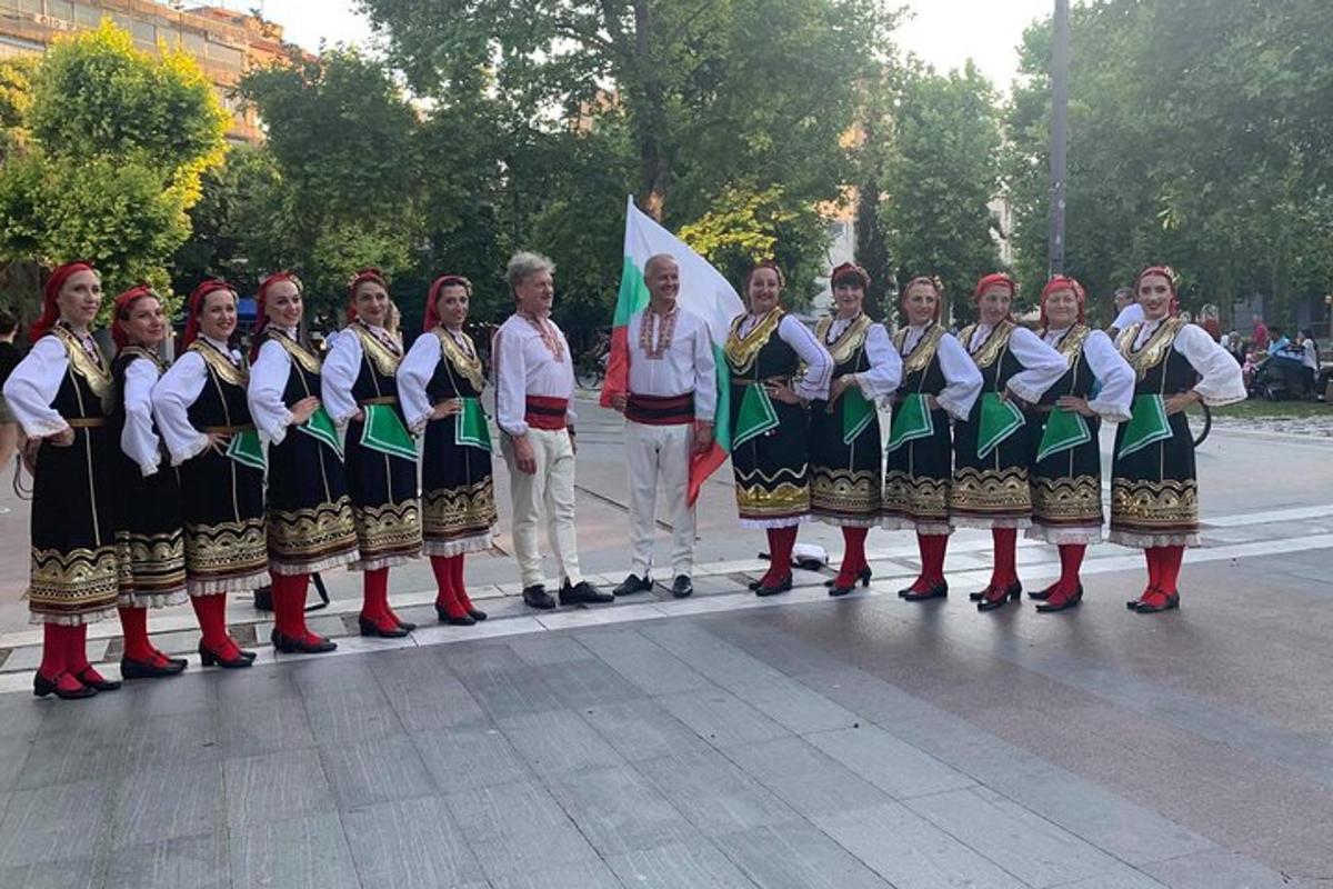 skupina žen stojících před vlajkou