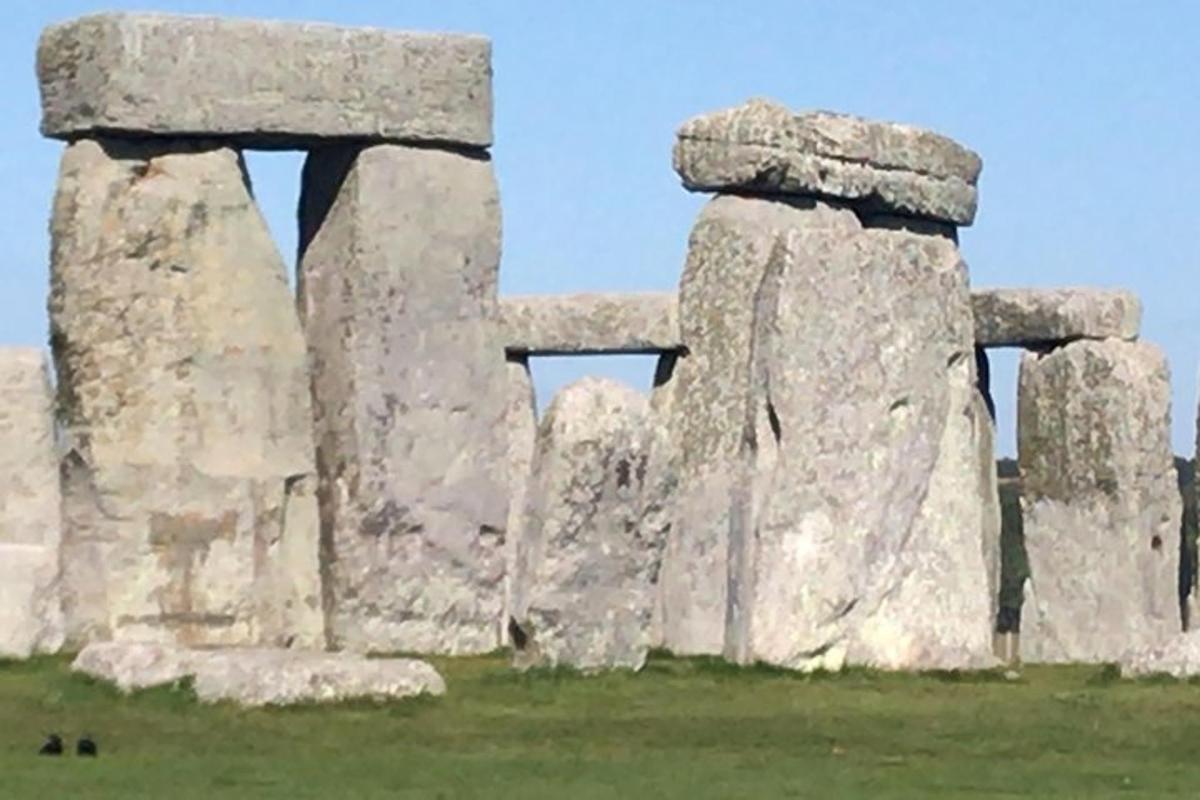 a stone structure with two windows in a field