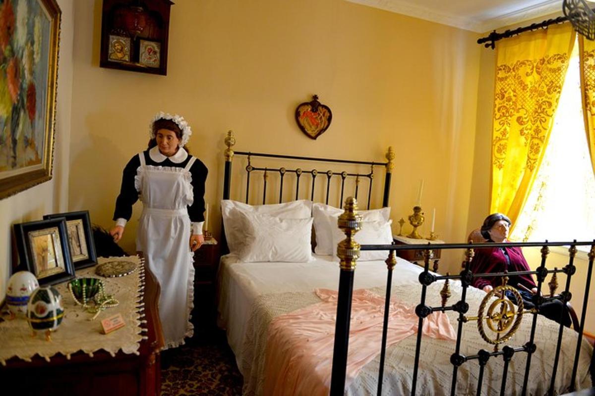 a man standing in a bedroom next to a bed