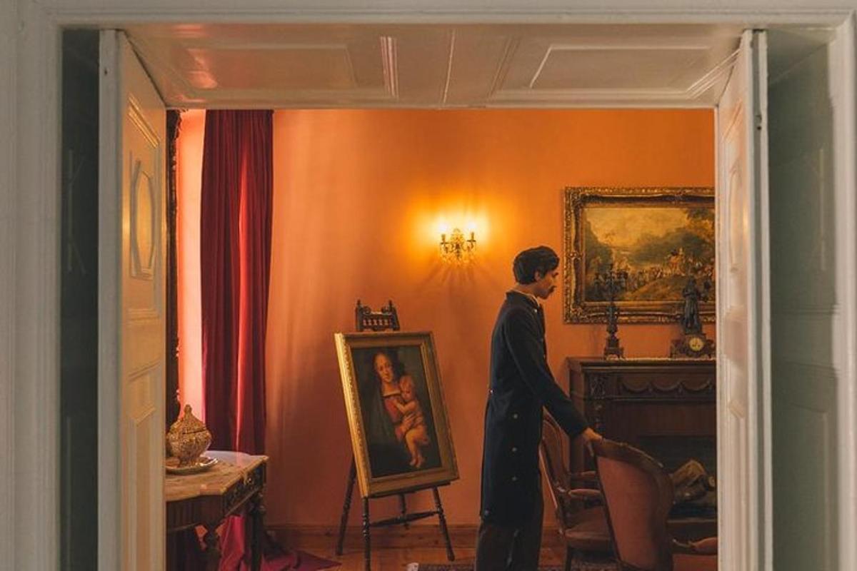a person standing in a room looking at a painting