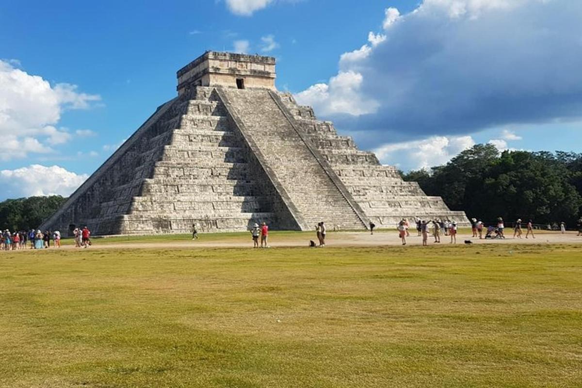 a pyramid with a lot of people walking around it