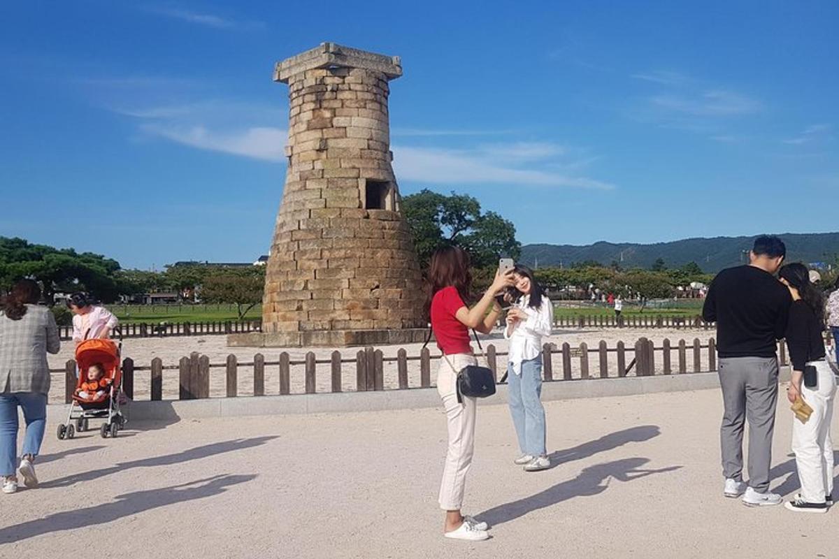 a woman taking a picture of a group of people on a bridge