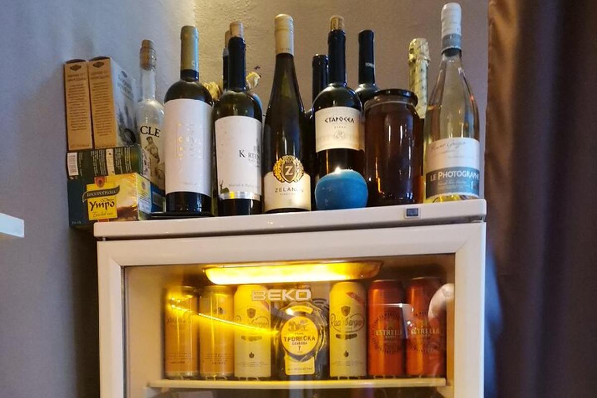 a bunch of bottles of wine sitting on top of a refrigerator