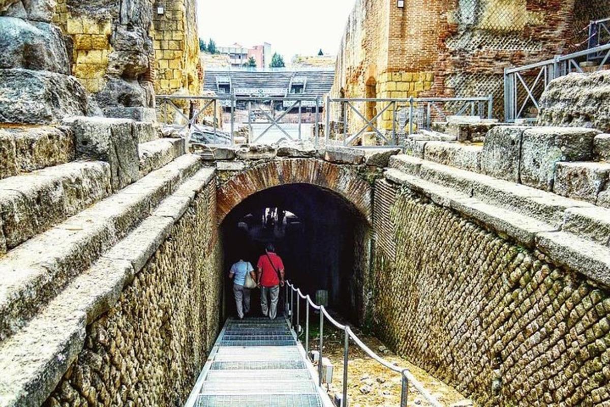 two people walking out of a tunnel