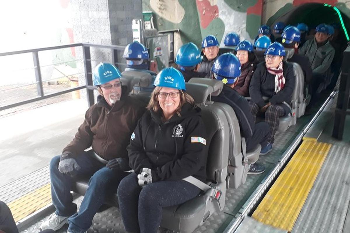 a group of people wearing blue hard hats on an escalator