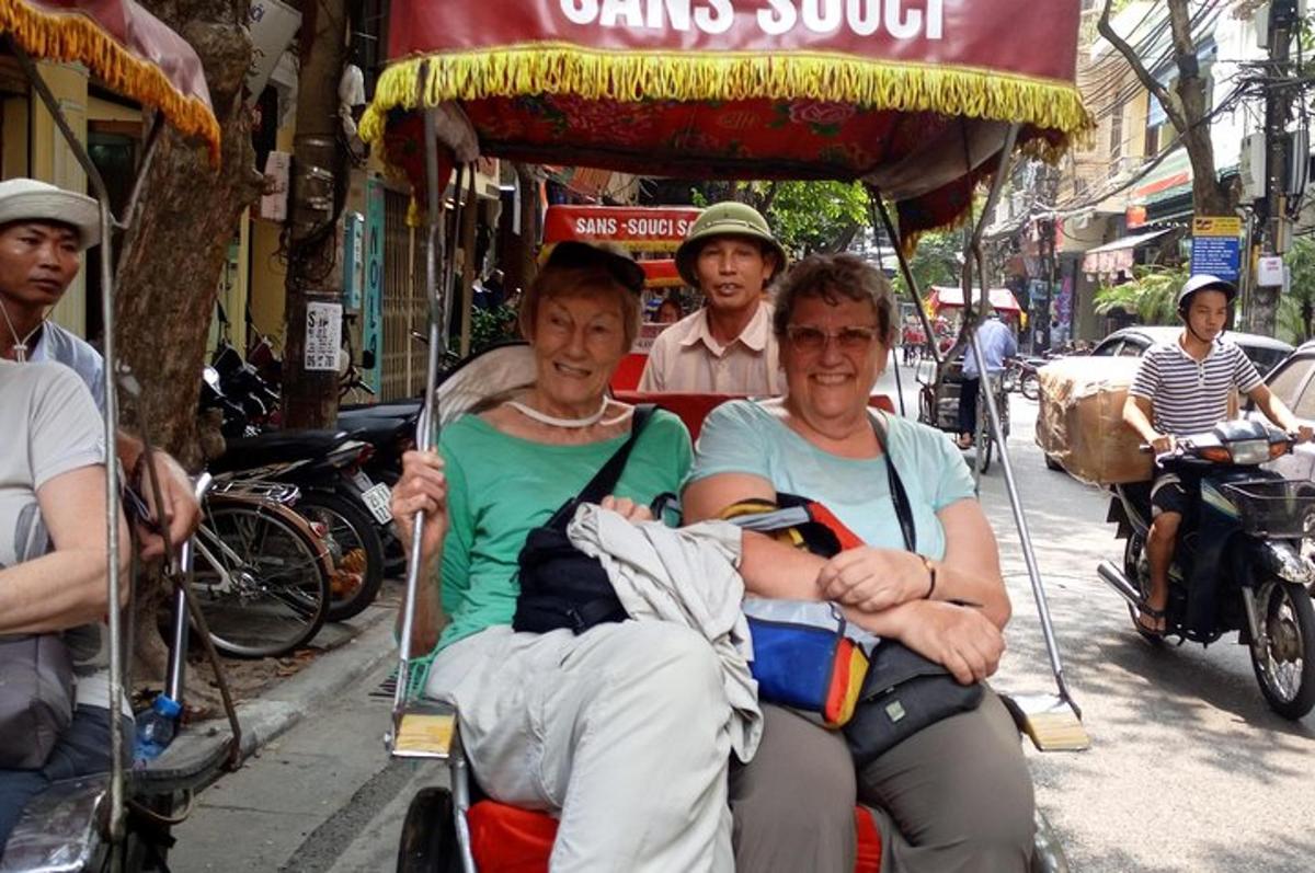 two men riding in a cart on a street