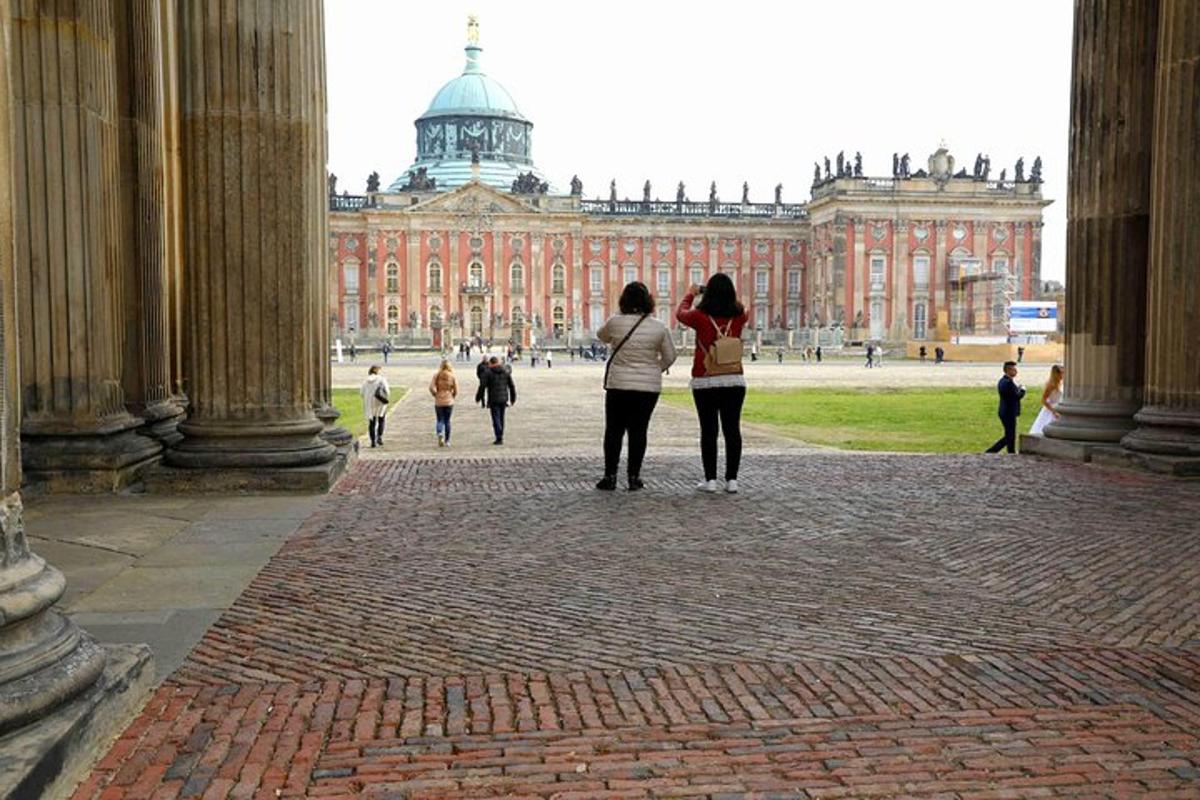 two women standing in front of a large building