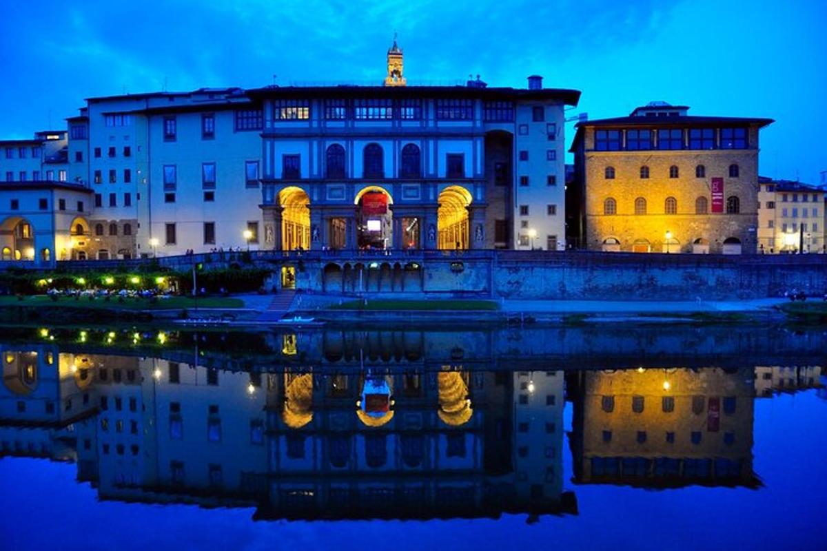 a building with its reflection in the water at night