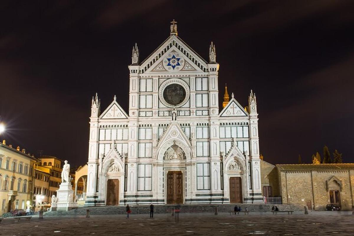 a large white building with a clock tower at night