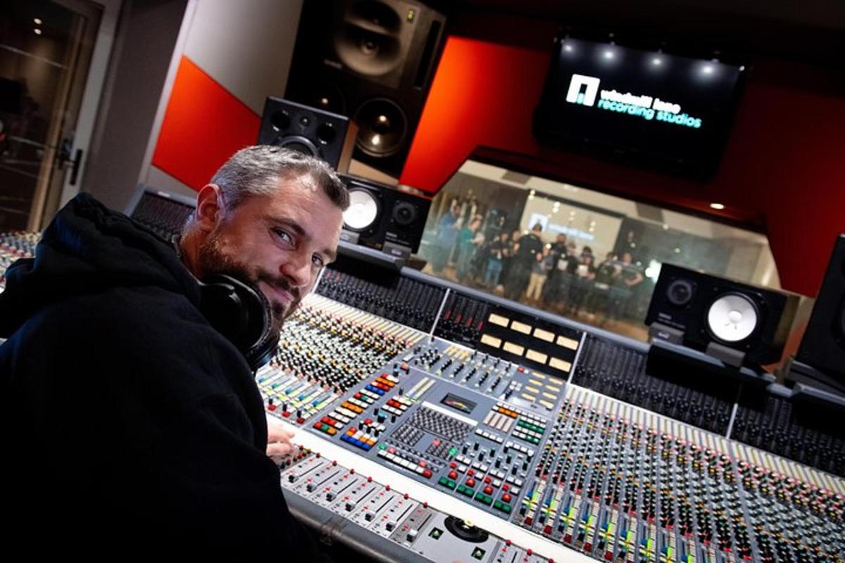 a man talking on a phone in a recording studio