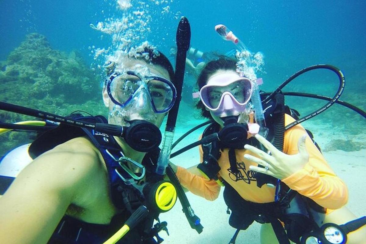 two people in the water with diving equipment