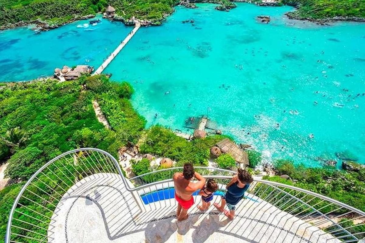 a group of three people standing on a staircase overlooking a body of water