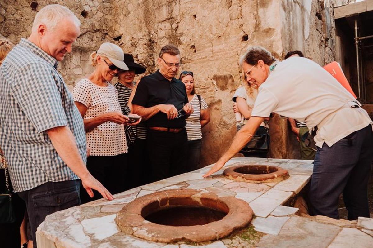 a group of people standing around a stone structure