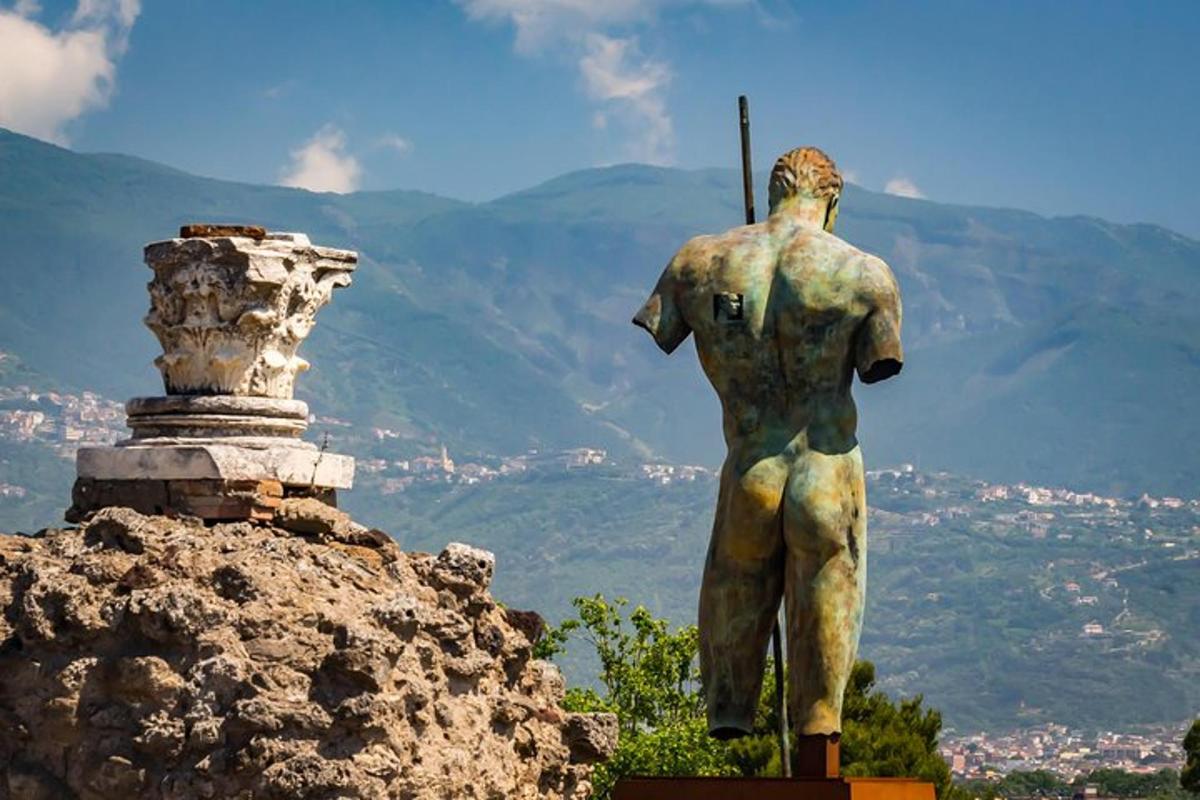 a statue of a man standing on top of a mountain