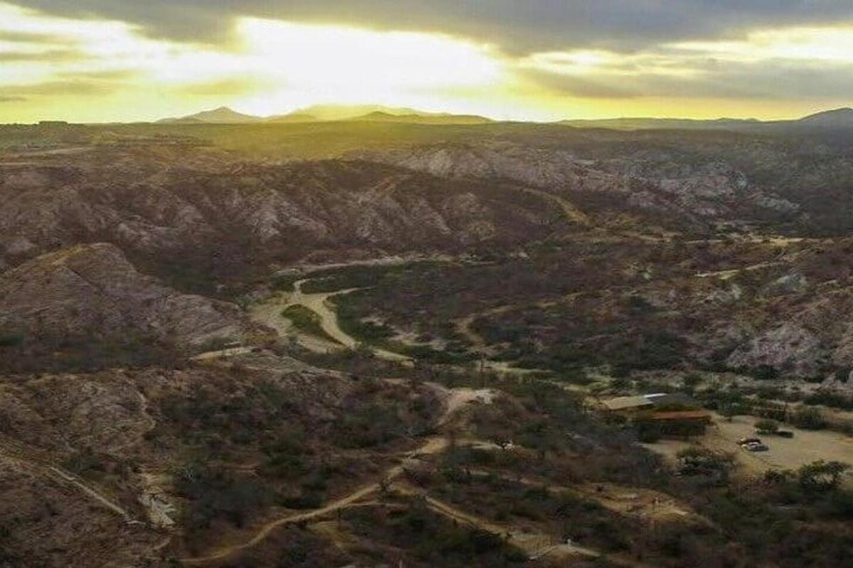 an aerial view of a mountain valley with a river
