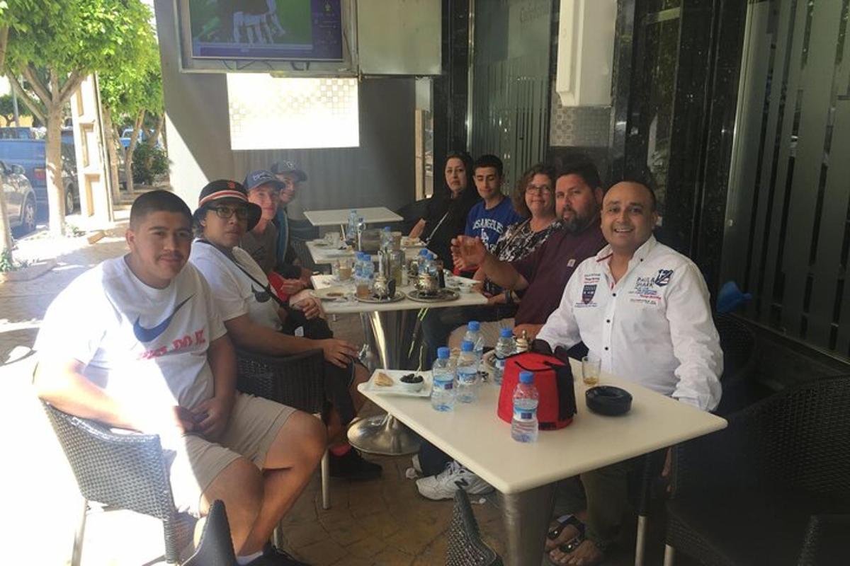 μια ομάδα ανθρώπων που κάθονται σε τραπέζια σε ένα εστιατόριο
