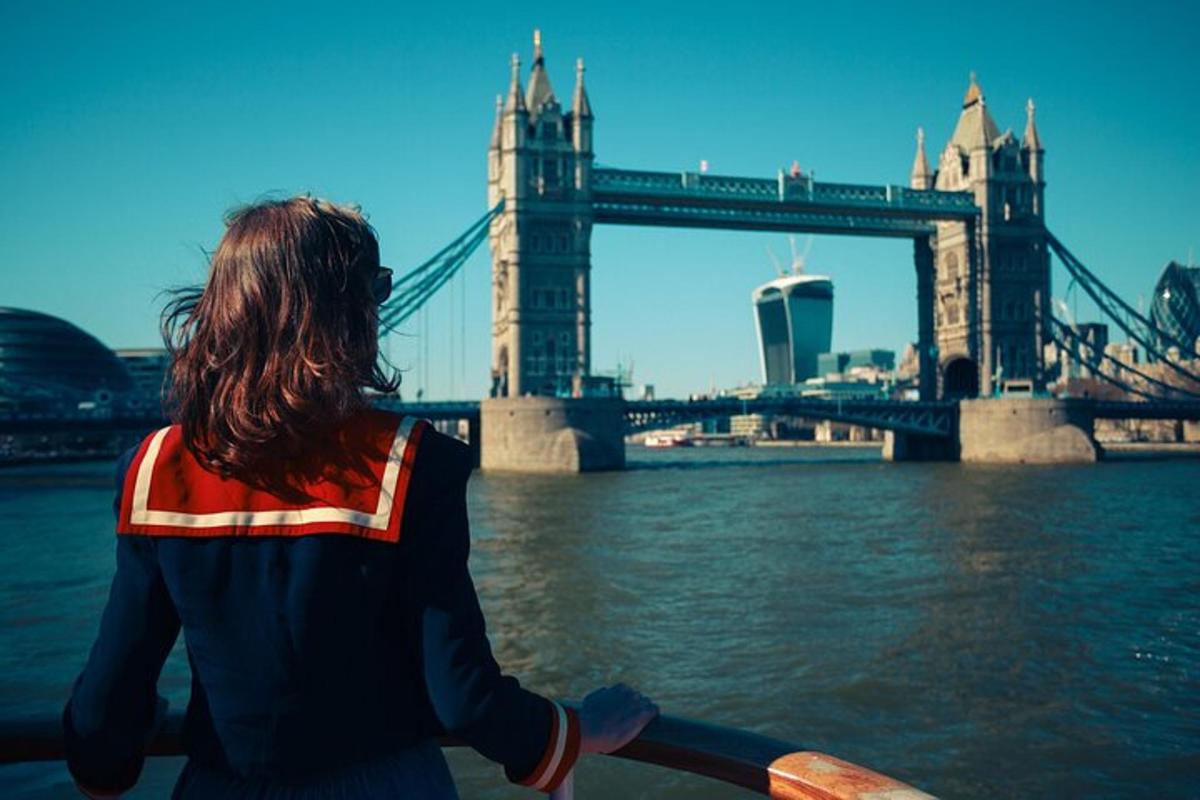 a woman on a boat in front of a bridge
