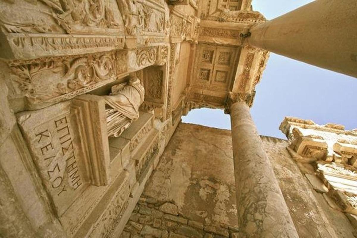 a stone building with a statue on the side of it