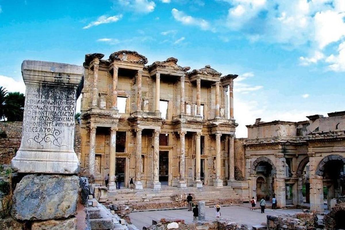 an ancient building with a pillar in front of it