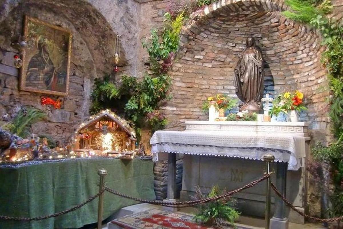 a room with a altar with a statue on a fireplace