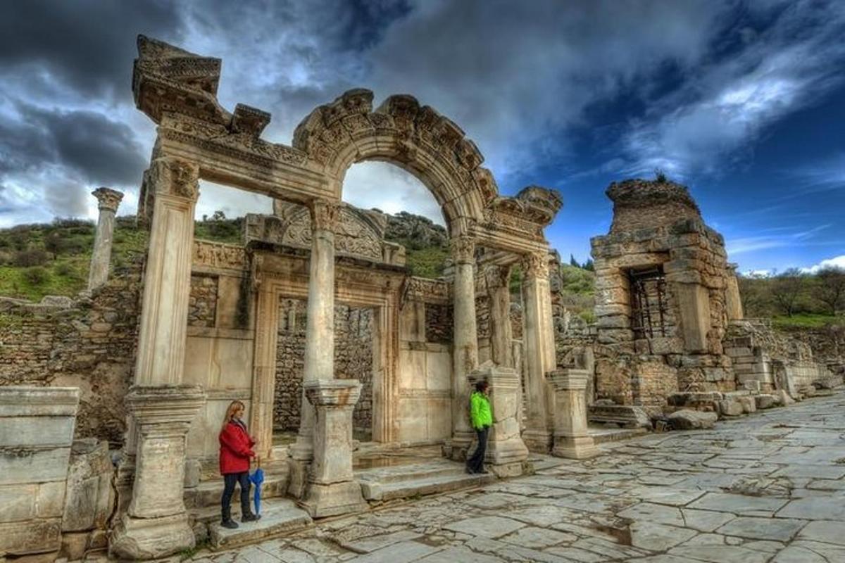 two people standing in front of an ancient building