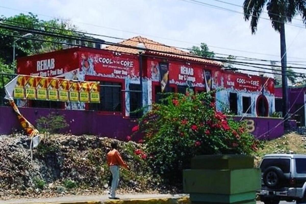 a person walking in front of a building with graffiti