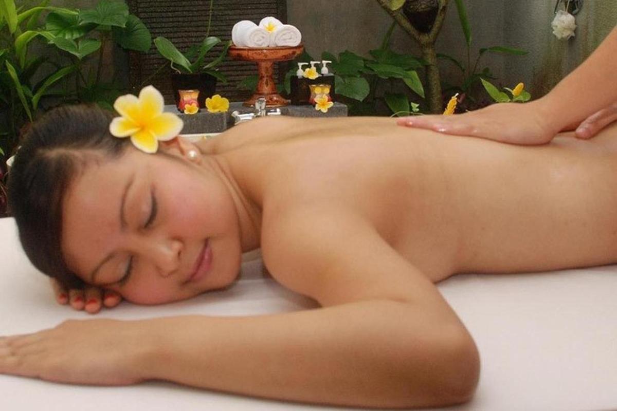 a woman getting a massage in a bathtub