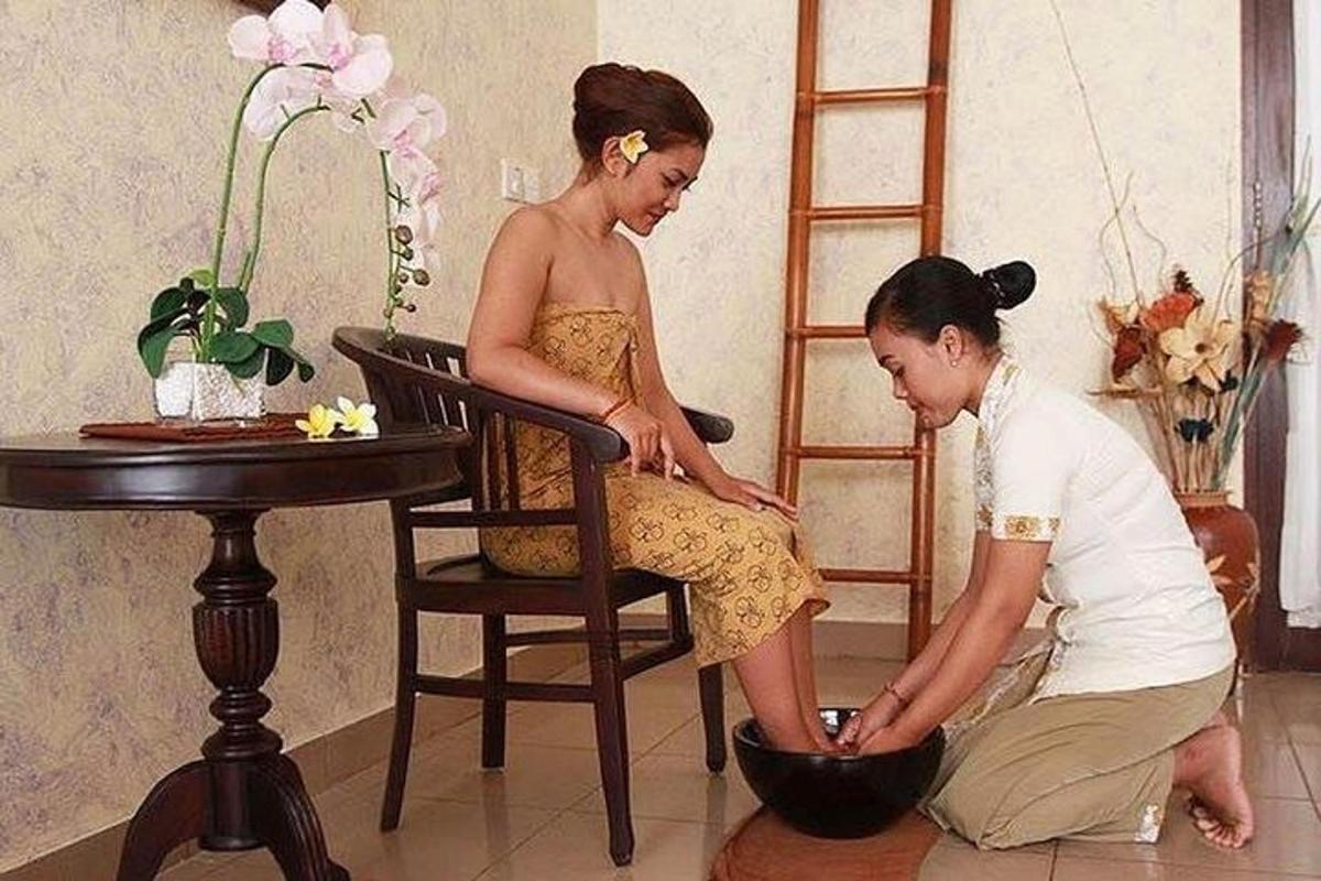 a woman sitting in a chair next to a girl