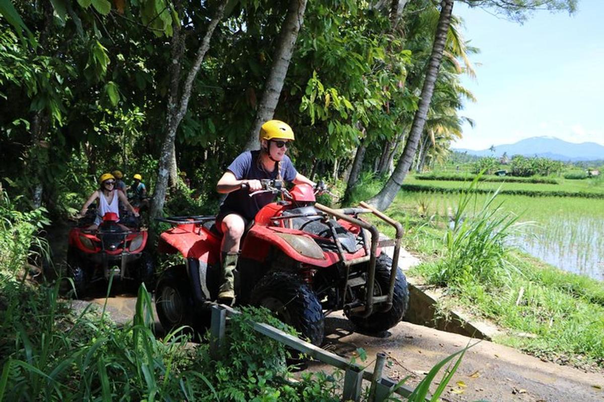 a man riding on a four wheeler on a trail