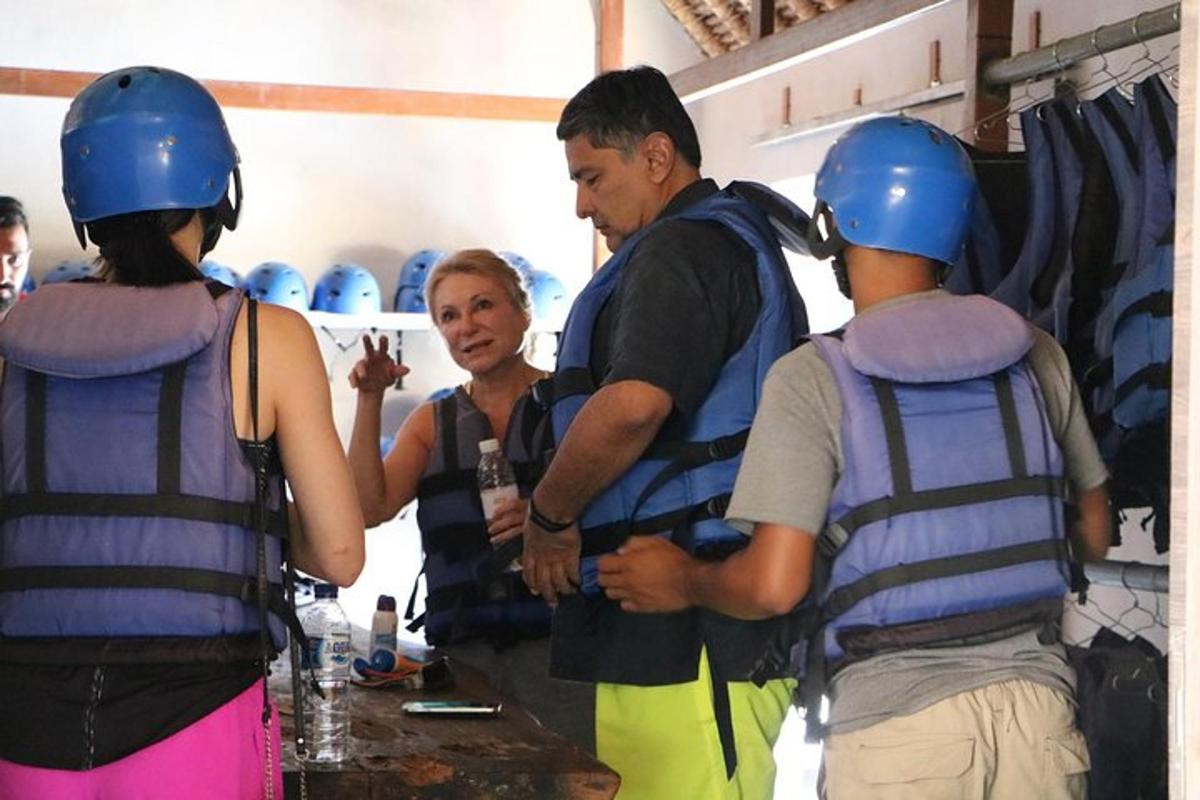 a group of people wearing helmets talking to a woman