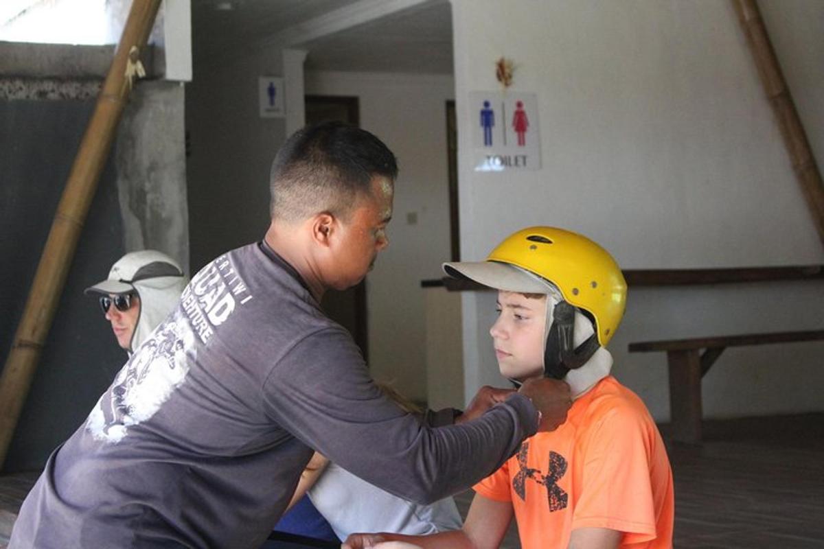 a man putting a helmet on a young boy