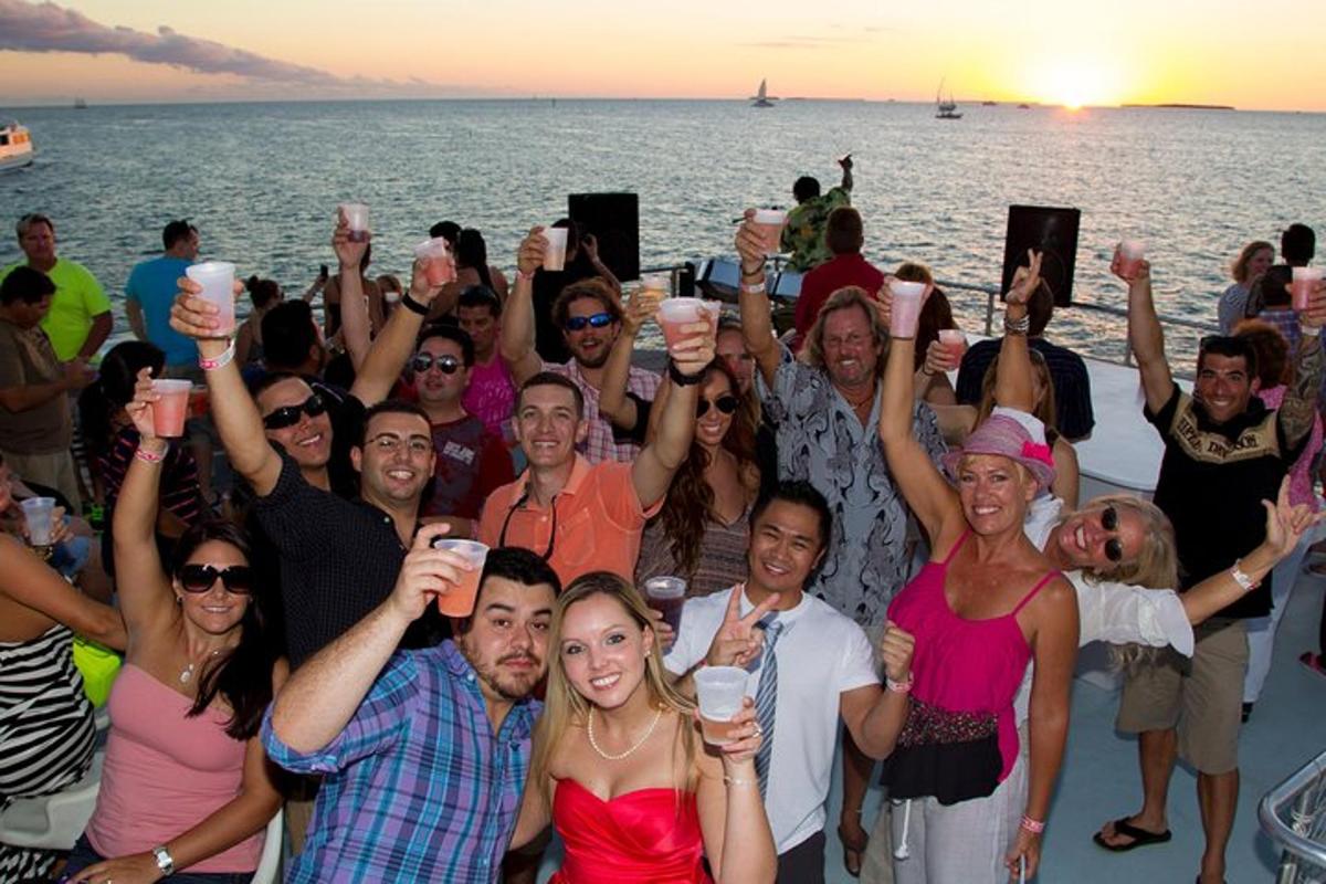 a group of people standing on a boat holding up their drinks