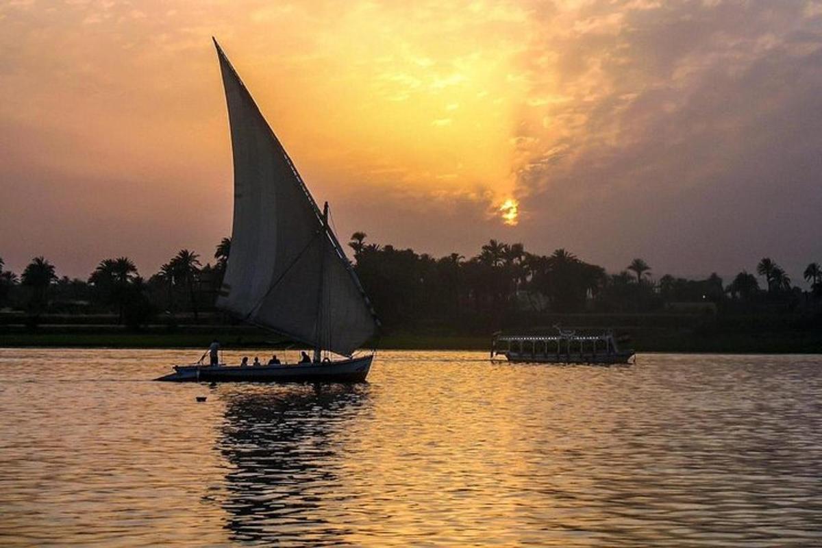 a group of people on a sail boat in the water