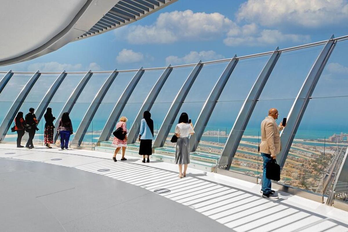 a group of people standing on the observation deck of a building