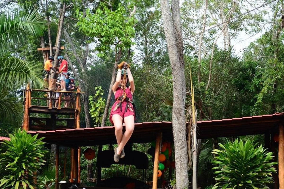 a woman taking a picture of a girl on a tree