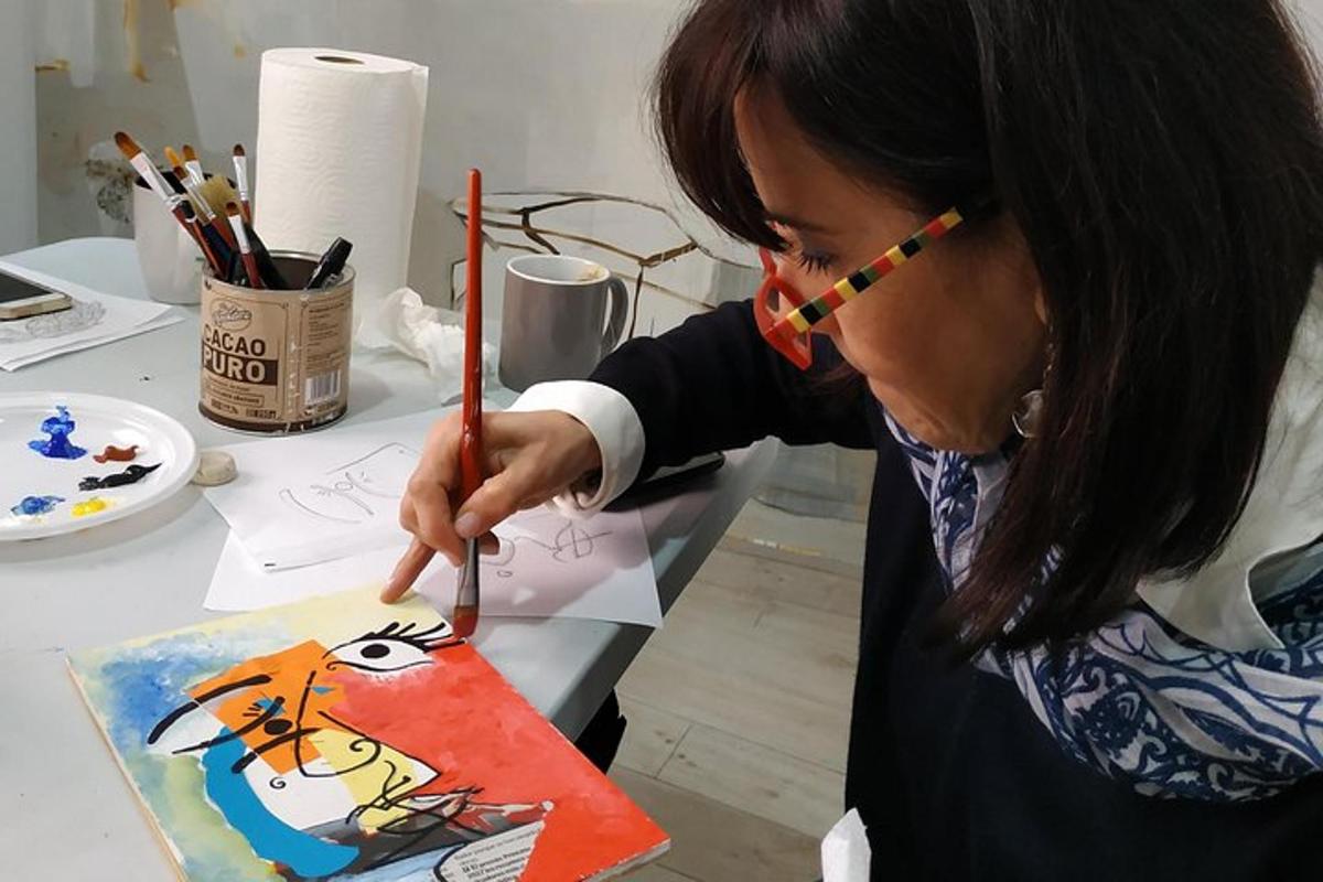 a woman cutting a cake with a painting of a cartoon