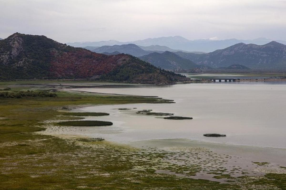 una gran masa de agua con montañas al fondo