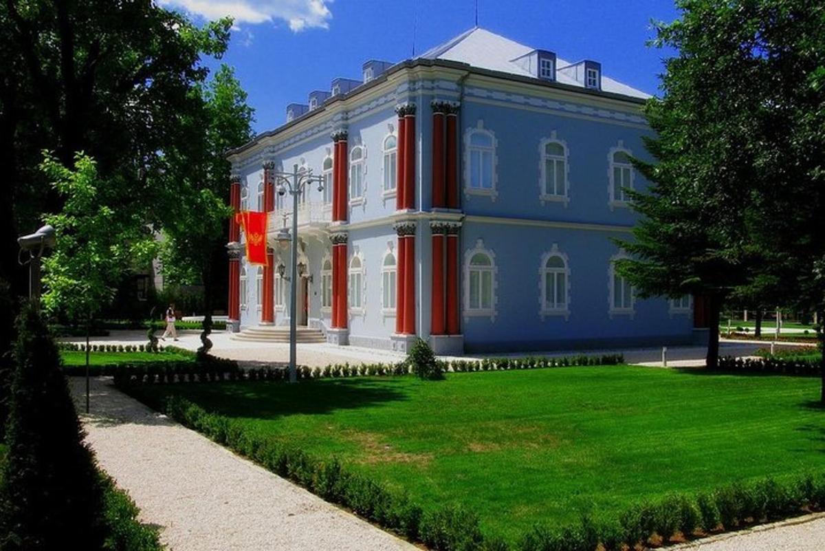 o clădire mare albastră și roșie cu o curte verde