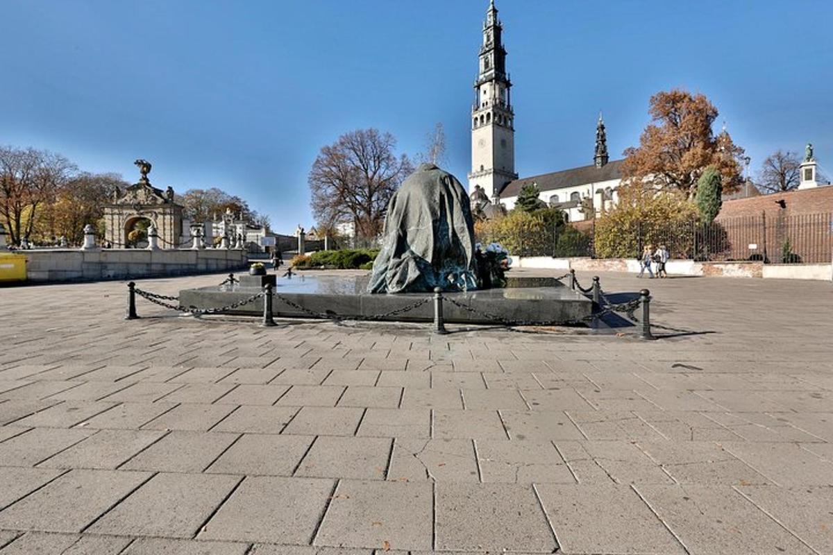 posąg na placu z kościołem w tle