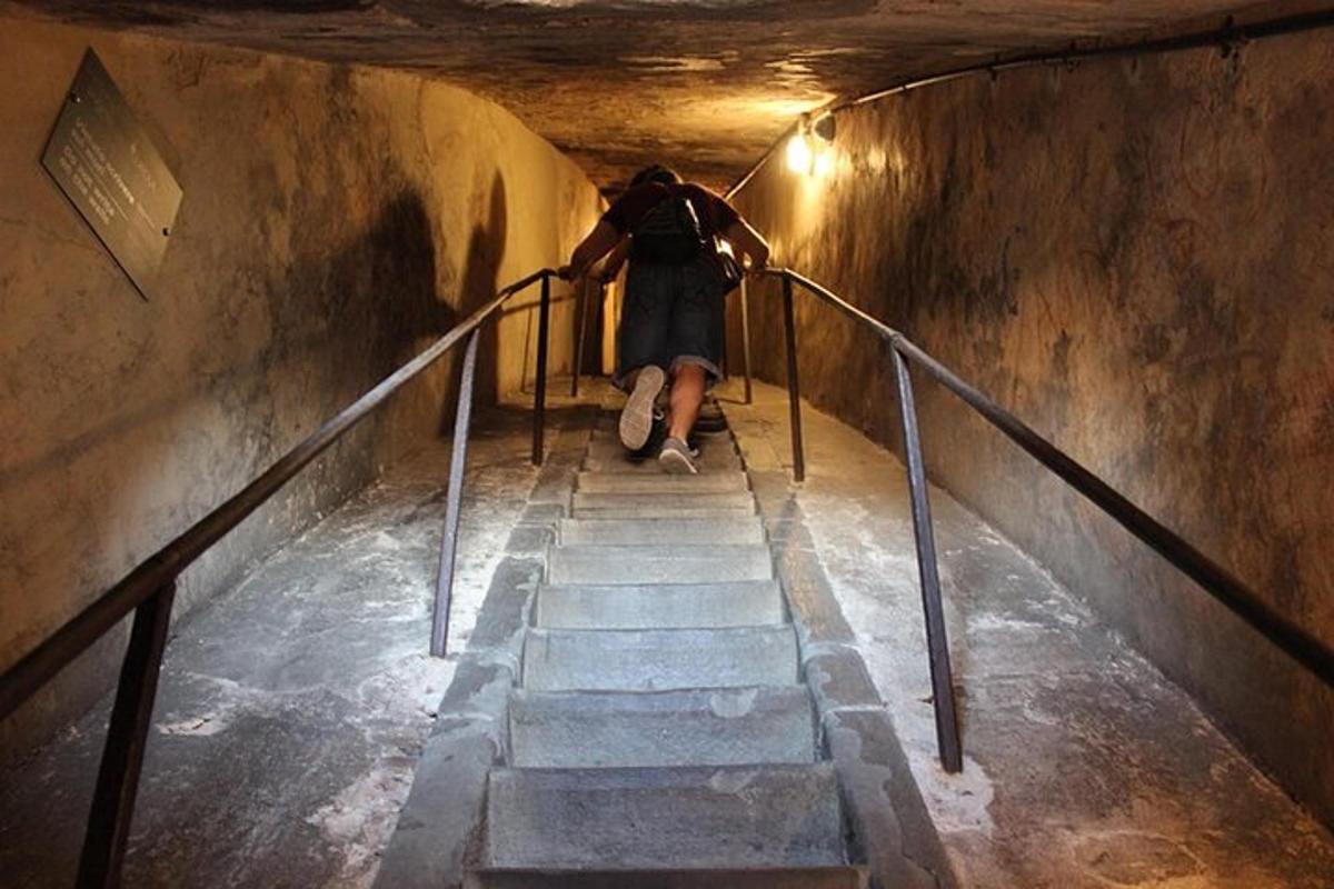 una persona està asseguda a les escales d'un túnel