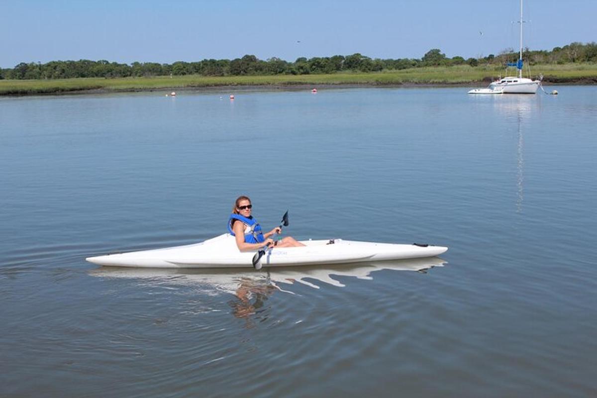 a woman sitting in a kayak in the water