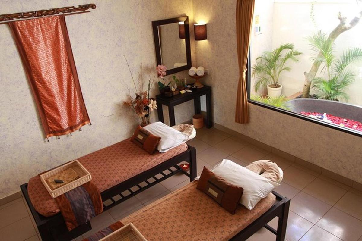 a bathroom with two beds and a bath tub