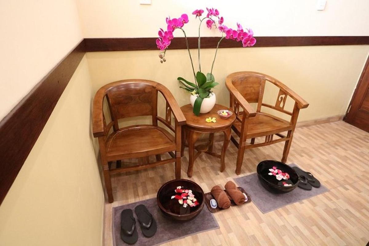 a dining room with two chairs and a table and flowers