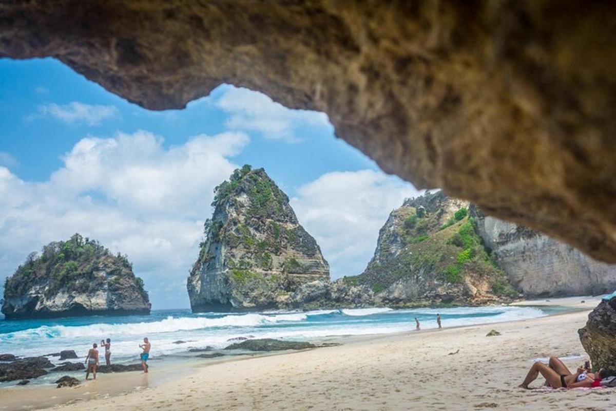 a view of a beach with people on the sand