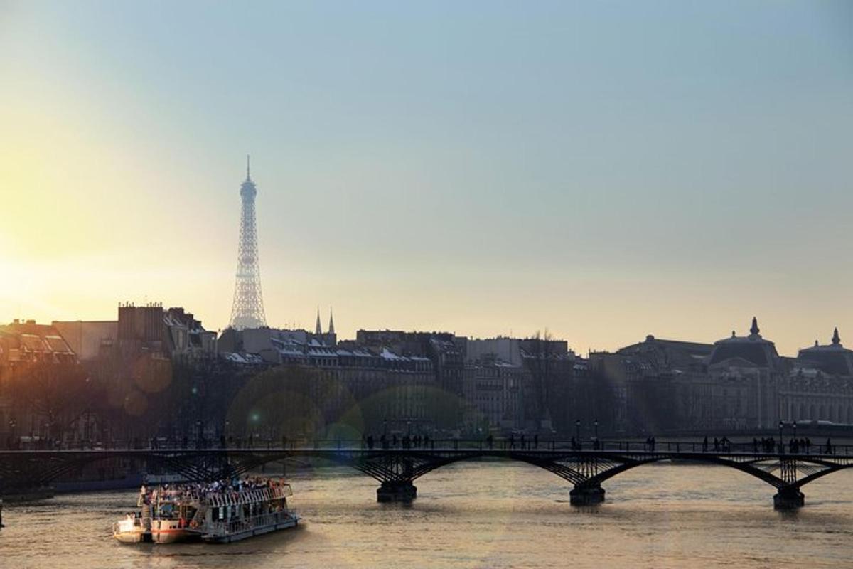 a boat on a river with a bridge and a tower