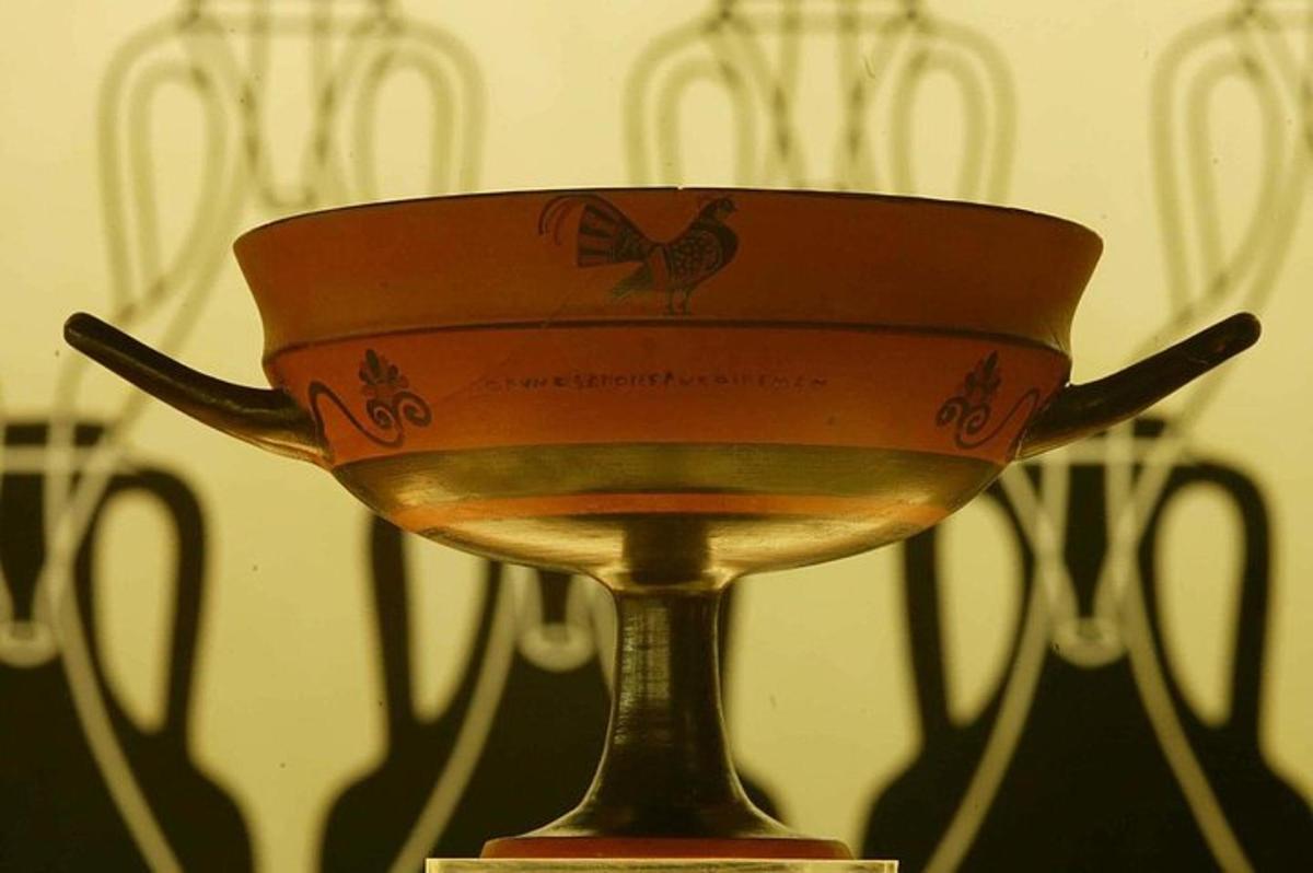 a gold trophy with a bird on top of it