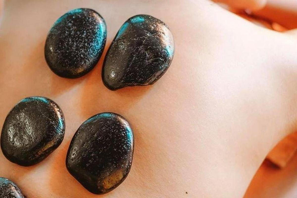a close up of a woman with black nails